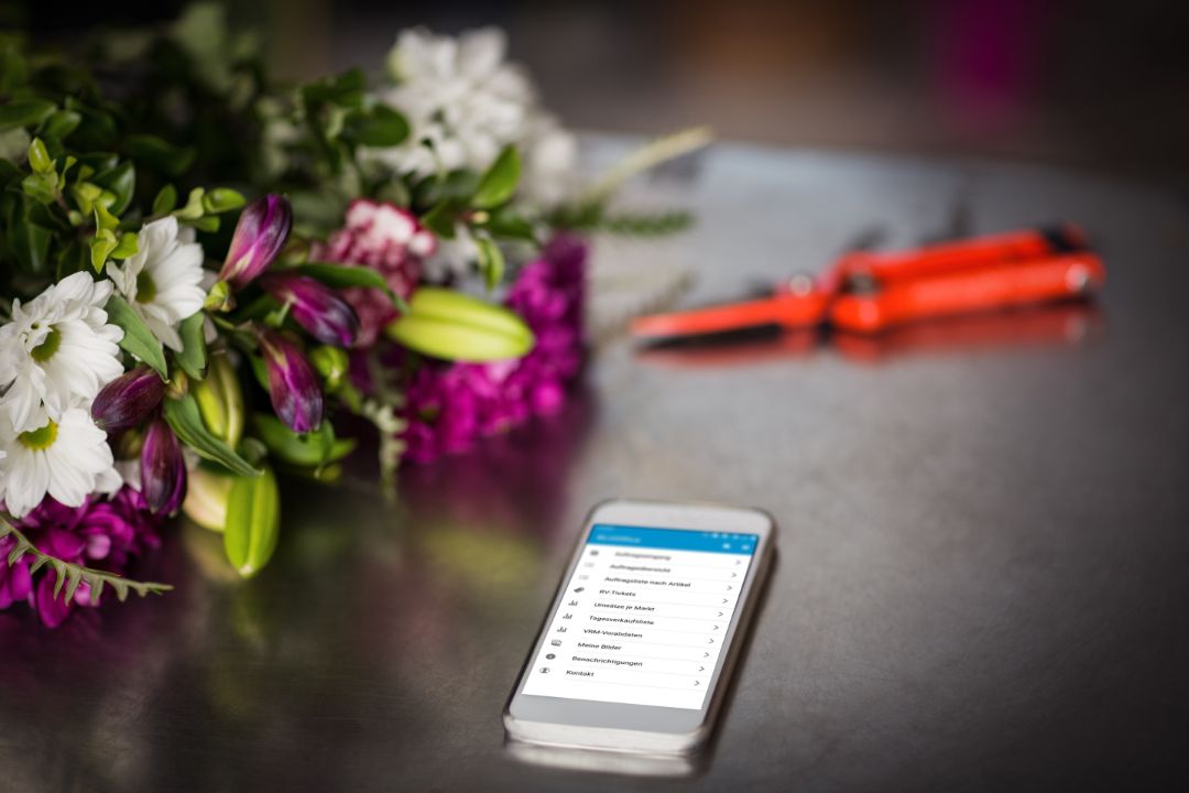 Close-Up of flowers and smartphone on the table
